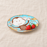 Blue monkey-pattern plate with strawberries