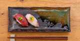 IM211-IK brown and green rectangular plate with nigiri on a wooden table