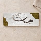 White rectangular melamine plate with olive accents on a tabletop