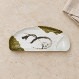 White half-round divided melamine plate with olive accents on a tabletop