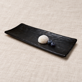 Black rectangular melamine platter with mochi and blueberries