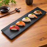 JX218-B long black ridged-edge platter with nigiri on a wooden table