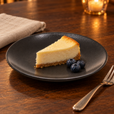 JX26-B round plate with cheesecake and blueberries in an evening setting