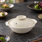 D8-K cream crackle-glazed ceramic donabe in a restaurant table setting