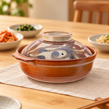 F8-K donabe with botanical lid in a dining setting