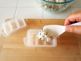 KK-285 three-cavity small oval onigiri mold being filled with rice