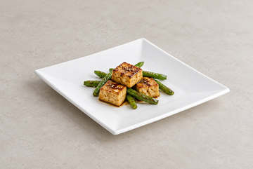 White square melamine plate in a savory serving scene