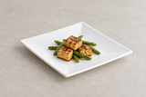 White square melamine plate in a savory serving scene