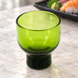 MF24-G green glass sake cup on a stone table