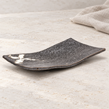 MK212W-WB curved dark platter with white brush accent, on a pale stone counter
