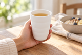 White horizontally banded teacup held at breakfast