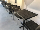 Mocha Stackable Indoor/Outdoor Chair with Black Aluminum Frame in a restaurant setting; other furniture is illustrative