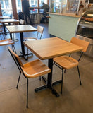 Natural solid ashwood seat and back restaurant chair with metal frame; restaurant setting with other furniture illustrative