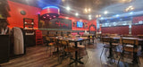 Natural solid ashwood seat and back restaurant chair with metal frame; restaurant setting with other furniture illustrative