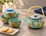 NT6-BT floral teapot and four cups beside a separate plate of two cookies and navy napkin; styling accessories not included