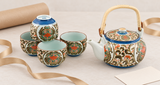 NT8-KK ornate teapot and four cups in original arrangement beside separate wrapping paper, ribbon and blank card
