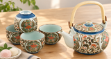 NT8-KK ornate teapot and four cups in original arrangement beside a separate dish of two mochi and linen