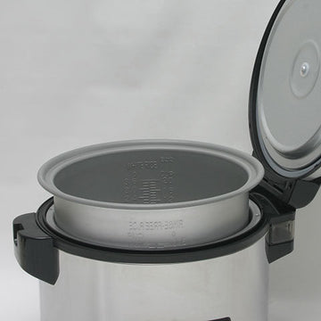 Zojirushi NYC-36 with lid open and nonstick inner cooking pan lifted to show its rice and water markings.