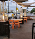 Orange open-back plastic restaurant chair; restaurant setting, other furniture illustrative