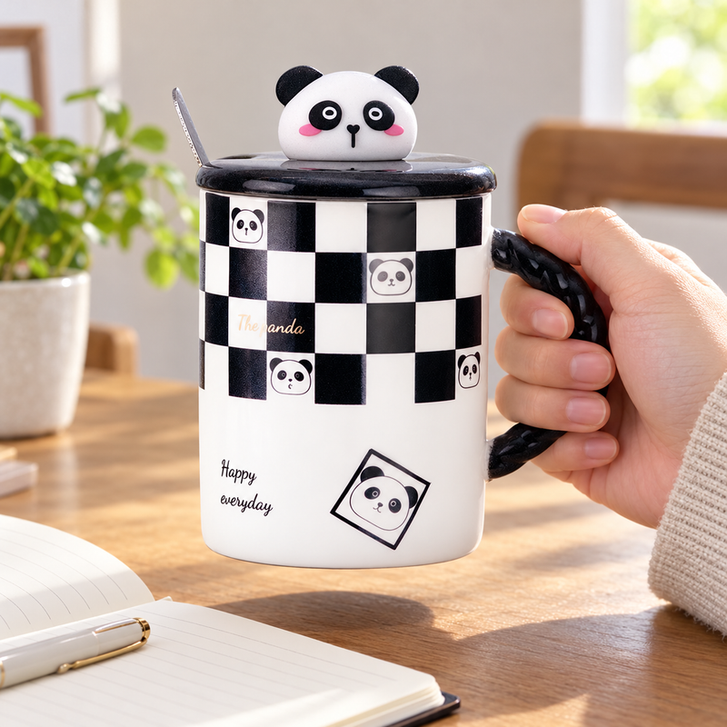 Checkerboard panda mug lifted by its braided handle beside a notebook