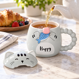 PC49-1 gray cat mug being filled with tea with its cat-face lid beside it