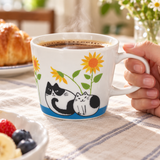 PH72-C2 cats and sunflower mug held by its handle during coffee service