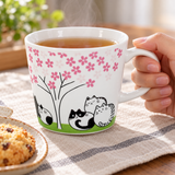 PH72-C1 cat and blossom tree mug held during tea service