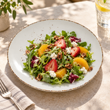 Splash Blanch large coupe plate with a fresh green and fruit salad