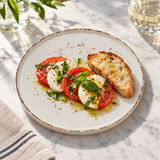 Splash Blanch stackable plate with a caprese starter and bread