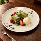 811A-E Eggplant-pattern melamine plate — Two small matcha cake slices with berries and a small scoop of vanilla ice cream within center, warm dark wood dessert table and fork outside plate