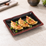 2406TM Tenmoku rectangular plate serving three gyoza on a pale stone table