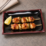 2408TM Tenmoku wave plate serving two chicken and scallion skewers with lemon