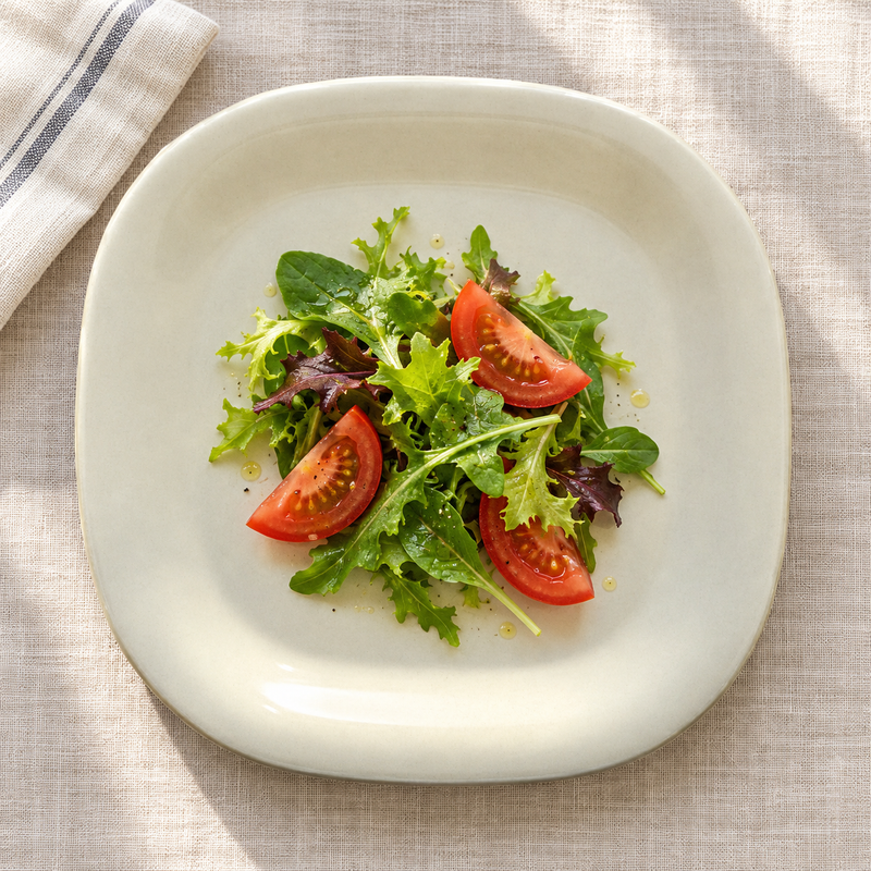 PS3008V Passion Pearl melamine plate with a small leafy salad and tomato wedges, serving suggestion