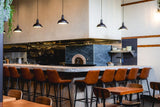 Pumpkin Upholstered Restaurant Barstool with Wood-Grain Metal Frame in a restaurant setting; other furniture is illustrative