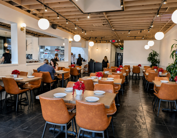 Pumpkin Upholstered Restaurant Chair with Espresso-Finish Metal Frame in a restaurant setting; other furniture is illustrative