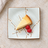 Square floral plate with dessert on a stone tabletop