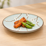 Round floral plate with food in a table setting