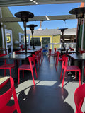 Red open-back plastic restaurant chair; restaurant setting, other furniture illustrative