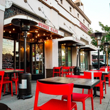Red open-back plastic restaurant chair; restaurant setting, other furniture illustrative