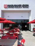 Red plastic restaurant chair; restaurant setting, other furniture illustrative