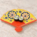 Yellow floral fan-shaped ceramic plate with cucumber maki