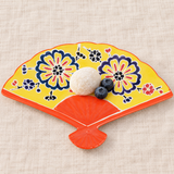 Yellow floral fan-shaped ceramic plate with mochi and blueberries