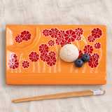 Orange floral rectangular ceramic sushi plate with mochi, blueberries and chopsticks