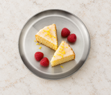 Round silver plate with cake in a tabletop setting