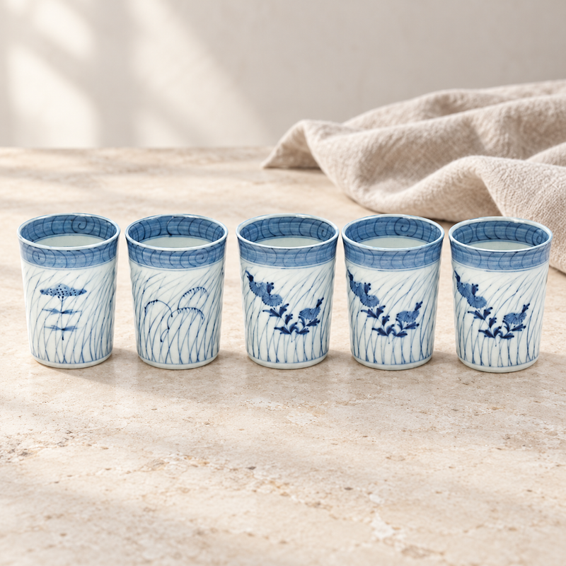 All five blue-and-white11790 sake cups in a pale linen tabletop setting