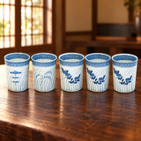 11790 blue-and-white five-cup sake set on a wooden restaurant table