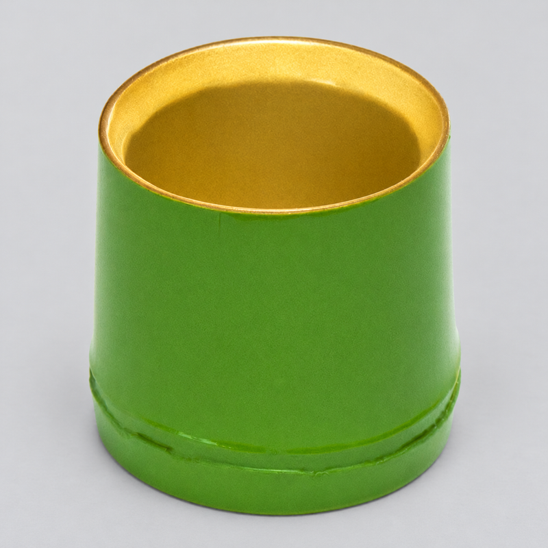 Elevated view of the green plastic sake cup showing its gold-colored interior and bamboo-node styling