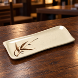 510-J beige bamboo-pattern rectangular plate on a wooden restaurant table