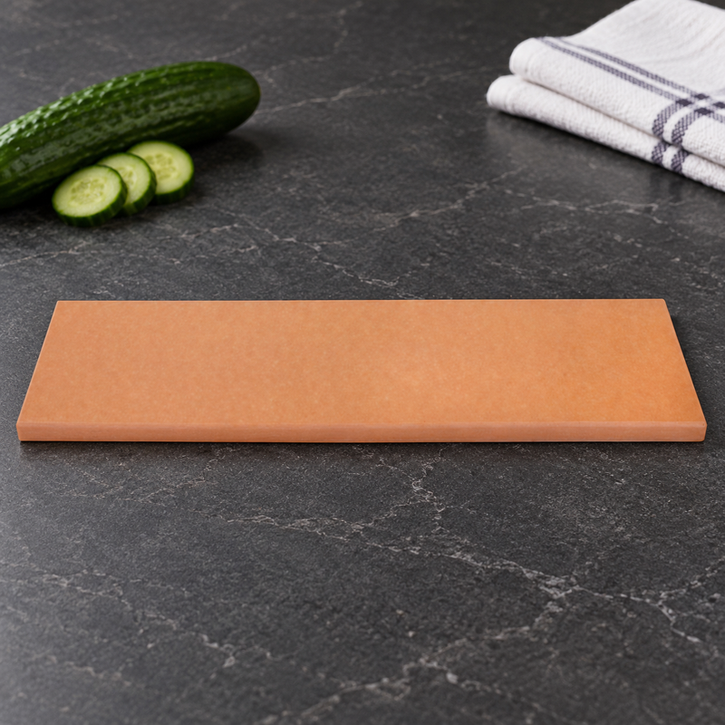 Long rectangular AG-111 rubber cutting board in a gray-counter preparation setting