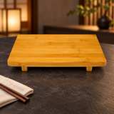 DJ-WDGT27 bamboo serving board shown empty on a restaurant table; surrounding tableware not included